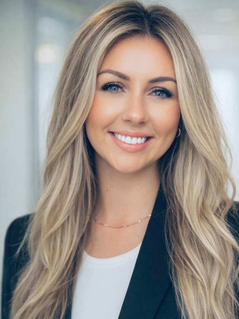 Smiling dental team member Lexsea McEown portrait at Nate Lewis DDS in a modern office setting